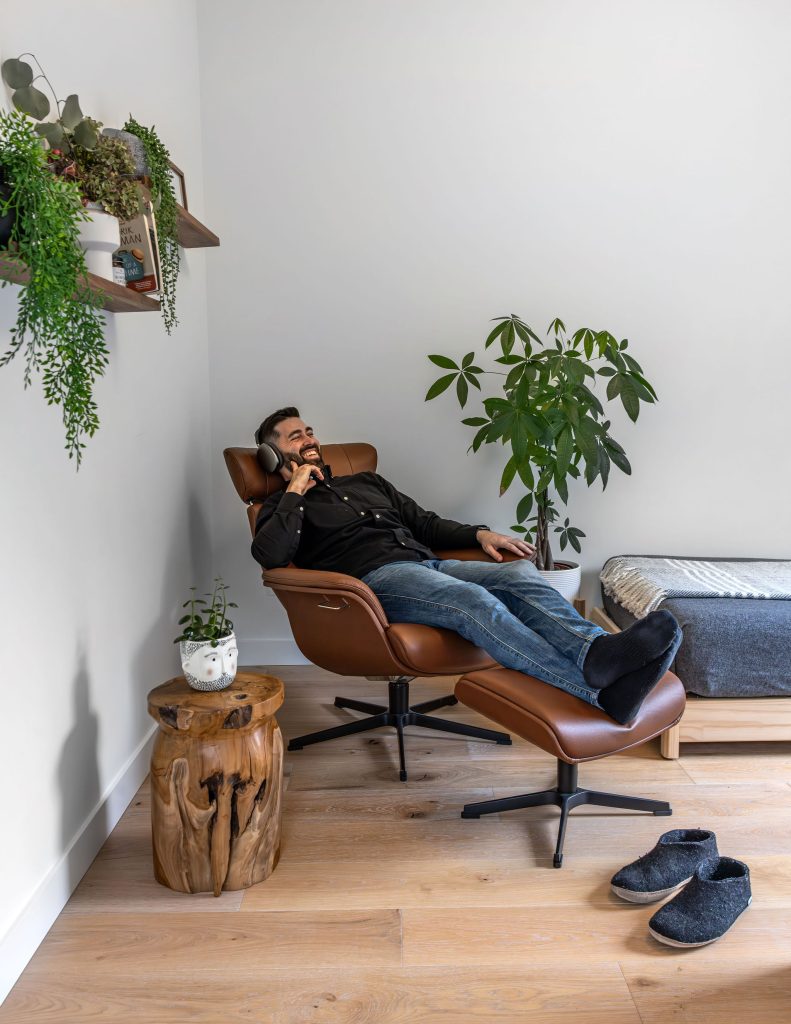Man lying back in a modern reclining chair