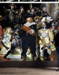 Robert Moore standing in front of his Night Watch mural in Saint John loft