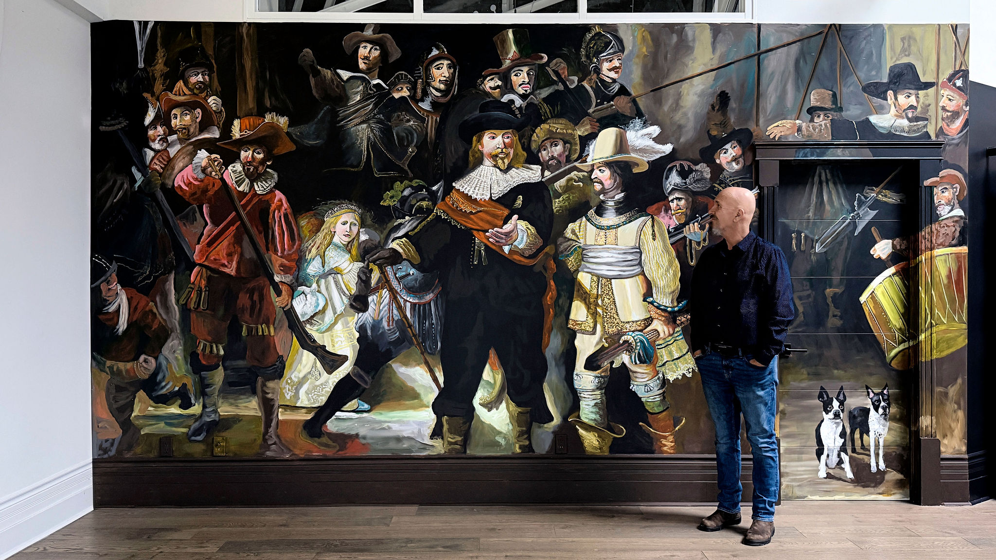 Robert Moore standing in front of his Night Watch mural in Saint John loft